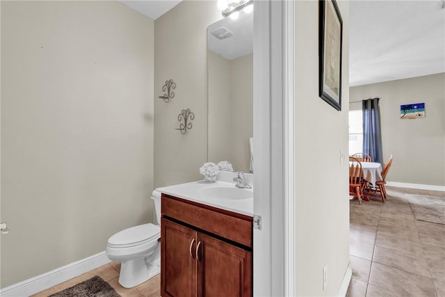 765 Fortunella Cir SW, Vero Beach, FL 32968 - bathroom with tile patterned floors, toilet, vanity, and baseboards