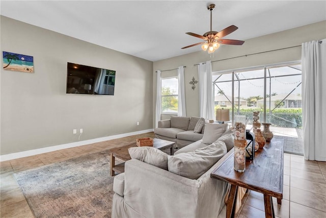 765 Fortunella Cir SW, Vero Beach, FL 32968 - living room featuring a sunroom, a ceiling fan, light tile patterned floors, and baseboards