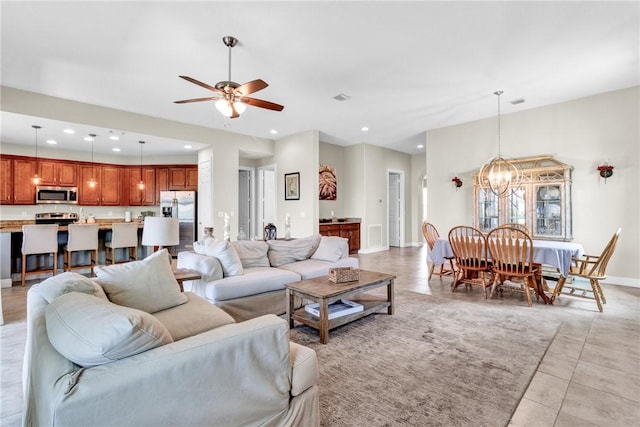 765 Fortunella Cir SW, Vero Beach, FL 32968 - living area with a ceiling fan, recessed lighting, light tile patterned floors, baseboards, and a chandelier