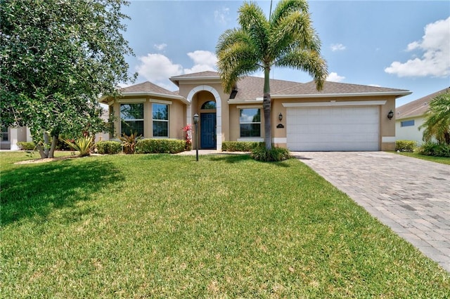 765 Fortunella Cir SW, Vero Beach, FL 32968 - view of front of house with stucco siding, a garage, decorative driveway, and a front yard