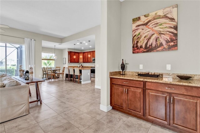 765 Fortunella Cir SW, Vero Beach, FL 32968 - bar featuring electric range, light tile patterned floors, hanging light fixtures, and baseboards