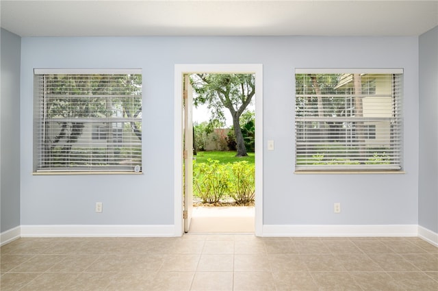 interior space with light tile patterned flooring and plenty of natural light