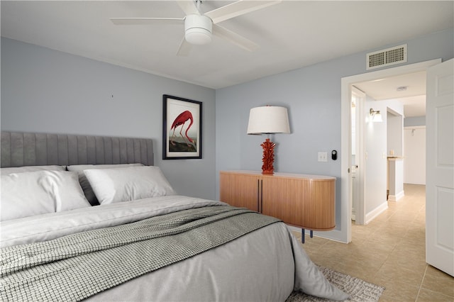 tiled bedroom featuring ceiling fan