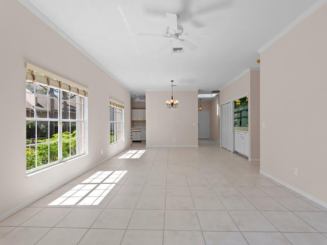 interior space with visible vents, ornamental molding, ceiling fan with notable chandelier, light tile patterned floors, and baseboards