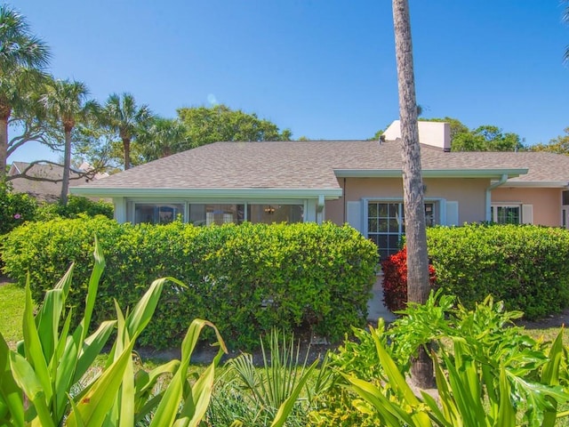 view of front of home featuring stucco siding and a shingled roof