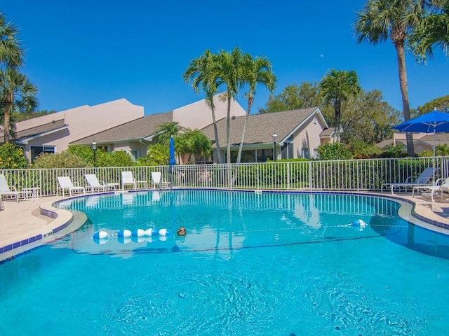 community pool featuring a patio area and fence