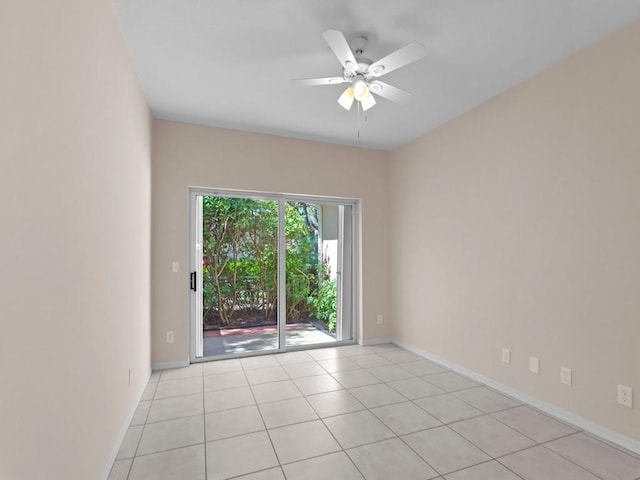 unfurnished room featuring light tile patterned floors, a ceiling fan, and baseboards