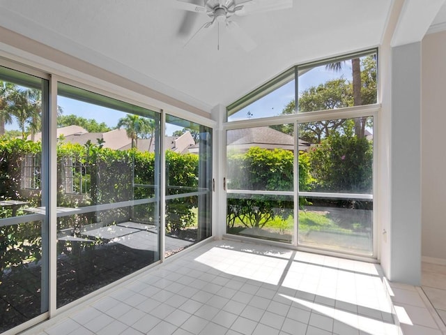 unfurnished sunroom featuring a healthy amount of sunlight, a ceiling fan, and vaulted ceiling