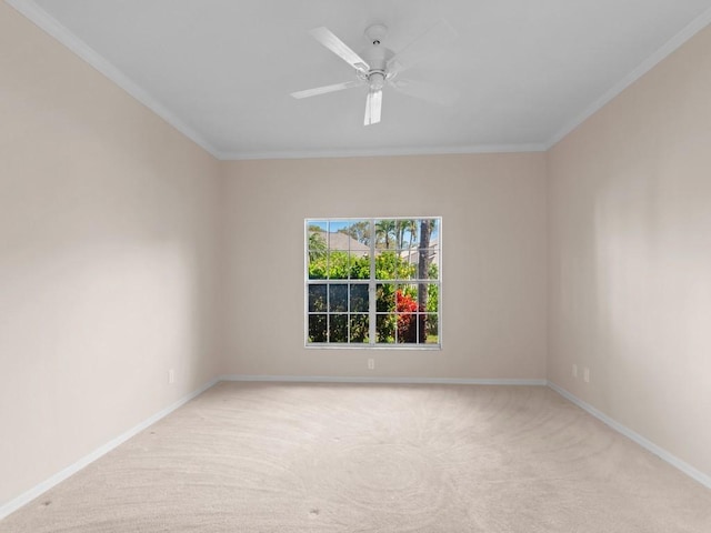 empty room with light carpet, ceiling fan, baseboards, and ornamental molding