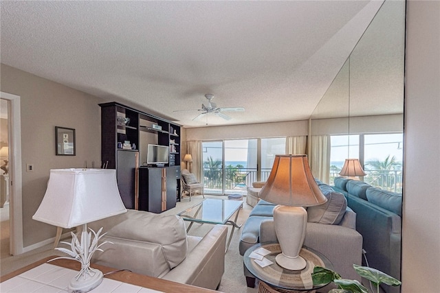 living room featuring a textured ceiling and ceiling fan