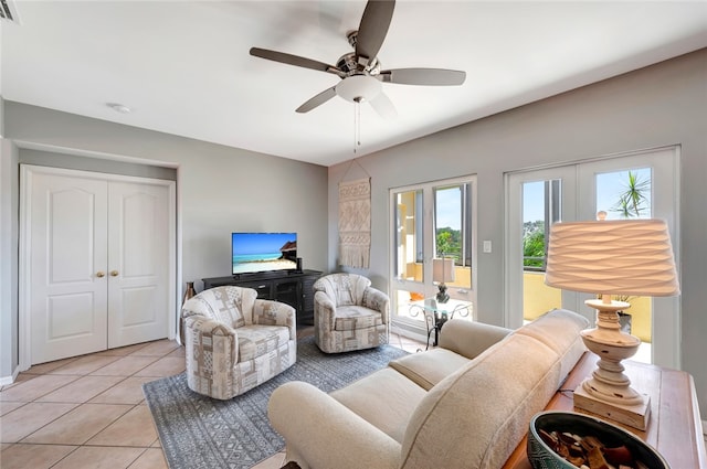 living room featuring light tile patterned flooring and ceiling fan