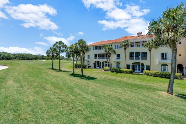 view of property's community with a lawn