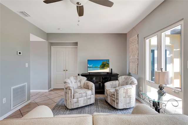 living room with light tile patterned floors and ceiling fan