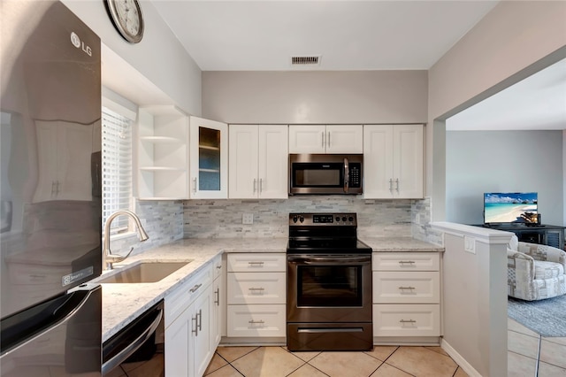 kitchen featuring stainless steel appliances, white cabinetry, and sink