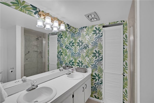 bathroom featuring an enclosed shower, vanity, and toilet