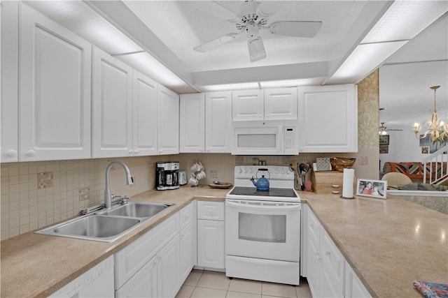 kitchen featuring decorative light fixtures, white appliances, sink, and white cabinets