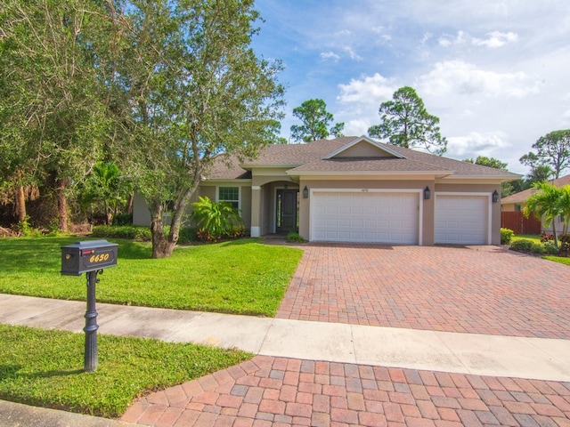 ranch-style home featuring a garage and a front lawn