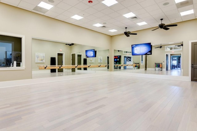 3577 Loblolly Sq, Vero Beach, FL 32966 - workout area with a towering ceiling, a ceiling fan, wood finished floors, a drop ceiling, and baseboards