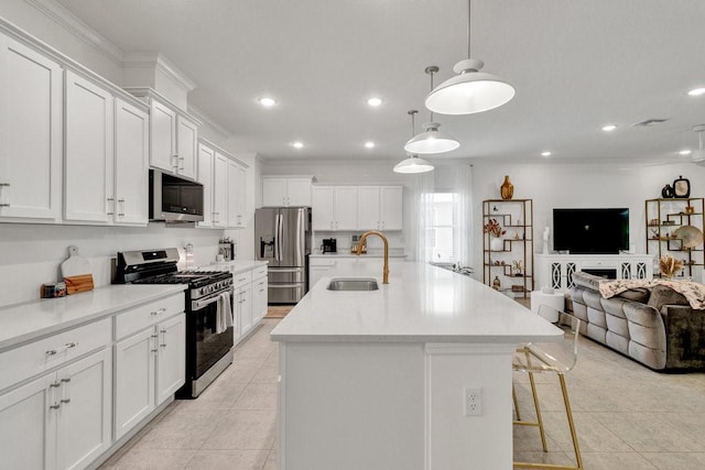 3577 Loblolly Sq, Vero Beach, FL 32966 - kitchen with stainless steel appliances, a sink, open floor plan, light tile patterned floors, and a kitchen island with sink