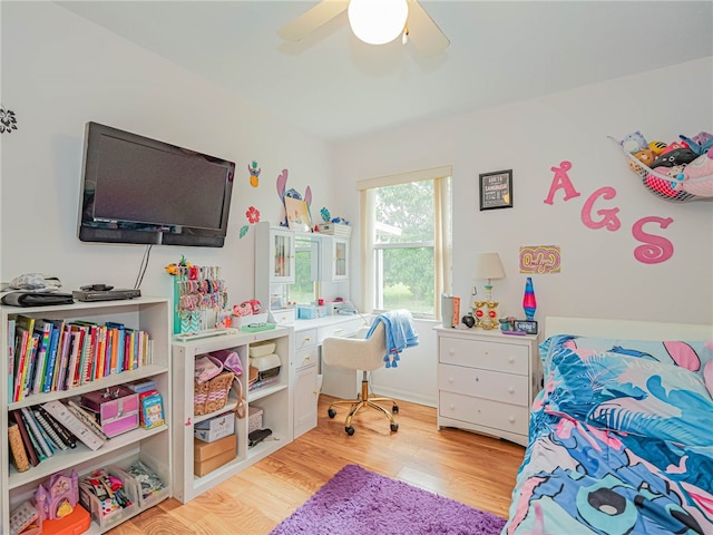 bedroom with ceiling fan and light hardwood / wood-style flooring