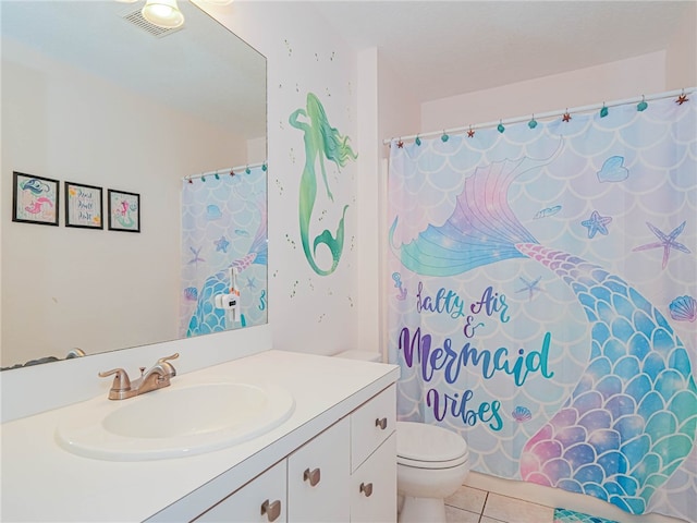 bathroom featuring toilet, vanity, tile patterned flooring, and curtained shower