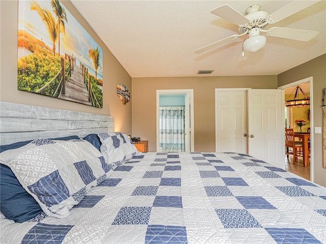 bedroom with ceiling fan and ensuite bath