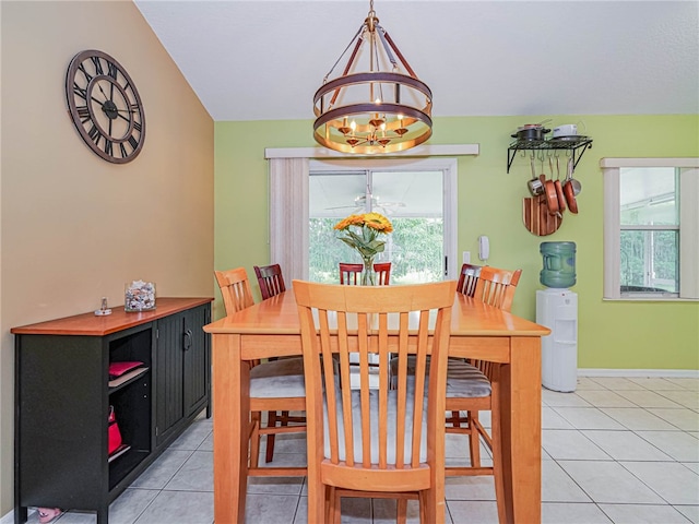 dining area with a notable chandelier and light tile patterned flooring