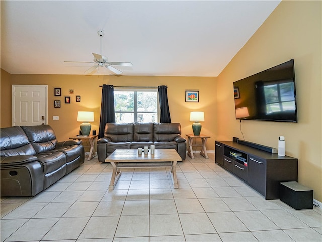 living room featuring lofted ceiling, light tile patterned floors, and ceiling fan