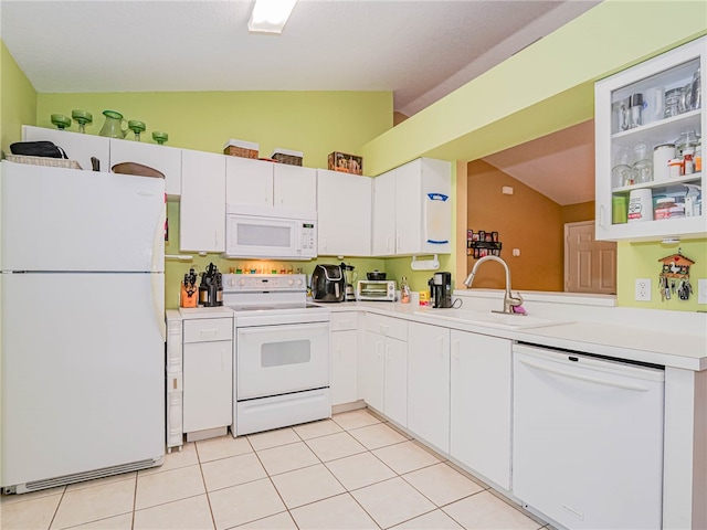 kitchen with white appliances, sink, lofted ceiling, and white cabinets