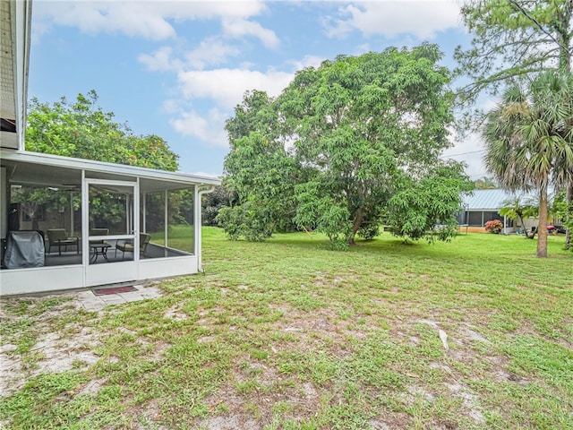 view of yard with a sunroom