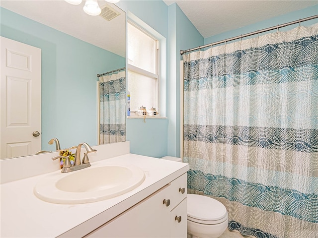 bathroom featuring toilet, a shower with curtain, and vanity