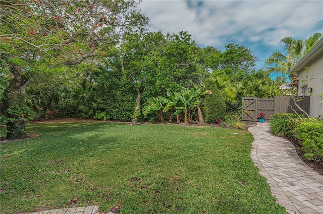 view of yard with fence and a gate