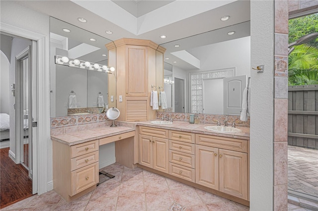 bathroom featuring recessed lighting, a sink, and double vanity