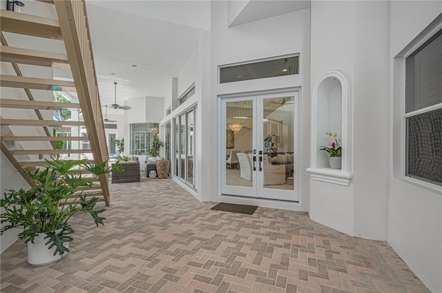 view of exterior entry featuring french doors and stucco siding