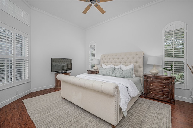 bedroom featuring crown molding, baseboards, ceiling fan, and wood finished floors