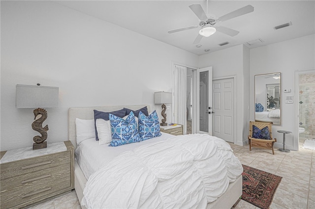 bedroom with visible vents, a ceiling fan, ensuite bathroom, and tile patterned flooring