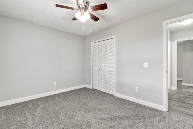 unfurnished bedroom featuring a textured ceiling, carpet floors, a closet, and ceiling fan