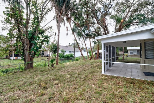 view of yard featuring a patio and a sunroom