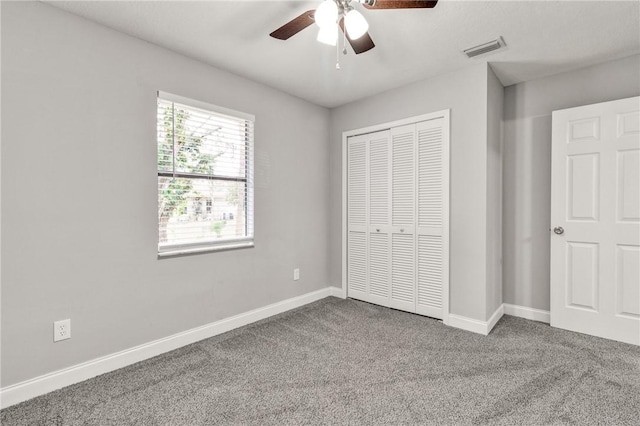 unfurnished bedroom with carpet flooring, ceiling fan, and a closet