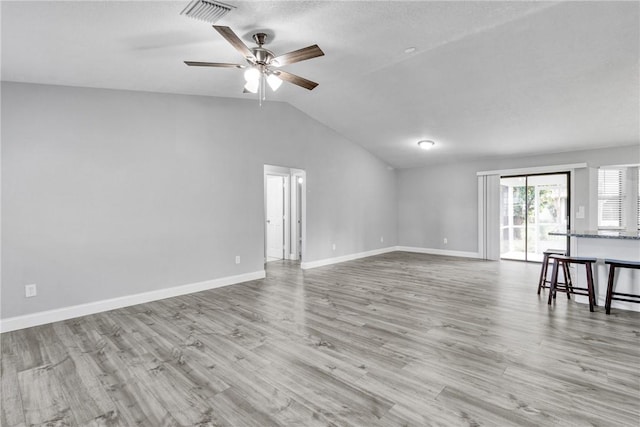 unfurnished living room with ceiling fan, light hardwood / wood-style flooring, and lofted ceiling