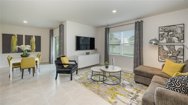 living room featuring recessed lighting, light tile patterned floors, and baseboards