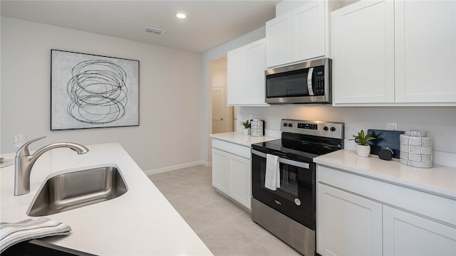 kitchen with visible vents, a sink, light countertops, appliances with stainless steel finishes, and white cabinetry