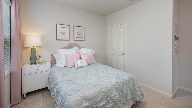 carpeted bedroom with baseboards