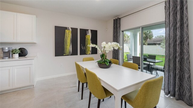 dining area featuring baseboards and light tile patterned flooring