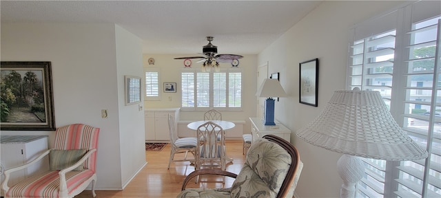 sitting room with a textured ceiling, light wood-type flooring, and ceiling fan