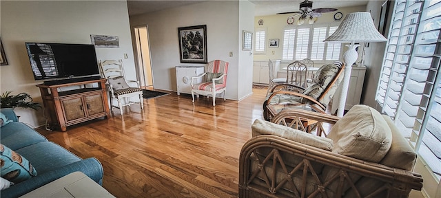 living room with hardwood / wood-style floors and ceiling fan