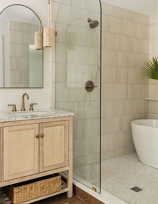 646 Honeysuckle Ln, Vero Beach, FL 32963 - bathroom with walk in shower, vanity, tile walls, tile patterned flooring, and a freestanding tub
