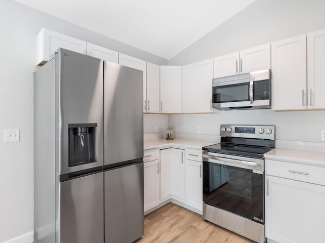 kitchen featuring white cabinetry, appliances with stainless steel finishes, lofted ceiling, and light wood-type flooring