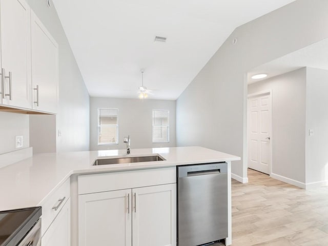 kitchen featuring sink, dishwasher, ceiling fan, white cabinets, and kitchen peninsula