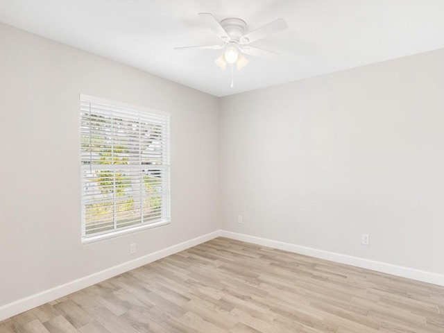 empty room with ceiling fan and light hardwood / wood-style floors